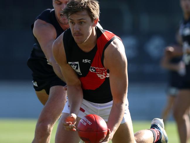 Aaron Heppell gathers possession for Essendon last season. 