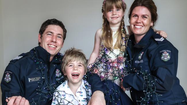 Police couple Emma Delbridge and Michael Putson, with children Ben and Penny, get their Christmas lights ready. Picture: Ian Currie