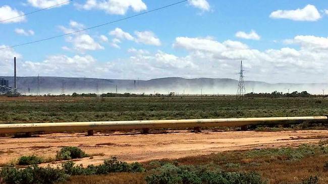 Wind carries the fly ash away from the closed Port Augusta power station.