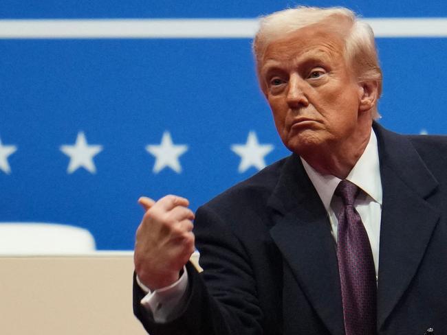 WASHINGTON, DC - JANUARY 20: U.S. President Donald Trump throws a pen after signing executive orders during an indoor inauguration parade at Capital One Arena on January 20, 2025 in Washington, DC. Donald Trump takes office for his second term as the 47th president of the United States.   Christopher Furlong/Getty Images/AFP (Photo by Christopher Furlong / GETTY IMAGES NORTH AMERICA / Getty Images via AFP)