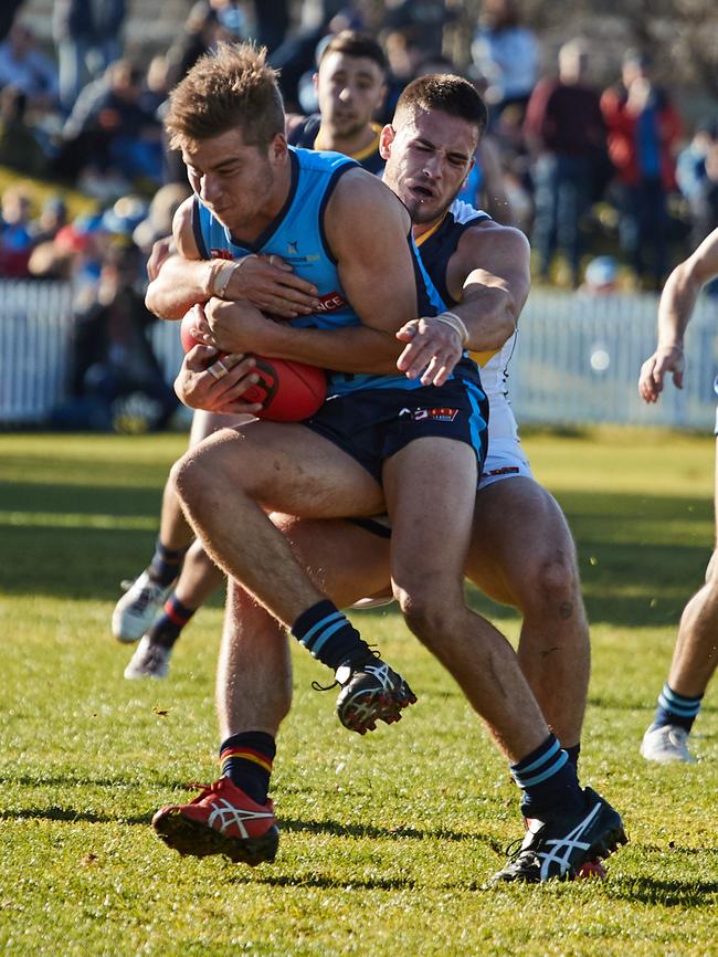 Adelaide's Lachlan Murphy tackles Sturt’s Josh Dodd at Unley Oval. Picture: AAP Image