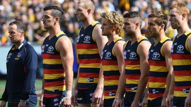 Crows coach Don Pyke and the Crows adopt their national anthem ‘power stance’ during last year’s grand final. Picture: AAP Image/Julian Smith