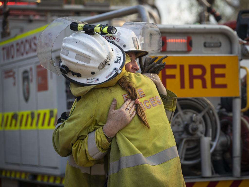 <b>TRACEY BACCI</b> <br/> <i>Two Rocks Volunteer<br/>Bushfire Brigade, Perth<br/>Years as a firefighter: Five<br/></i> Their faces and uniforms blackened by layers of toxic soot and ash, members of the Two Rocks Volunteer Bushfire Brigade thought they had the blaze they were battling in Perth’s north under control. Then the wind changed. “It kept changing direction and started as a small fire that ended up being 13,000ha,” says Tracey Bacci. As the temperature soared to 43C, the fire burst it containment lines and drew closer to suburban Perth. “I noticed the fire had jumped into the backyard of one of the volunteers,” Bacci says. The blaze was burning in the backyard of her friend, Wendy Noone, a longstanding member of the Two Rocks brigade. Bacci and fellow firefighter Tara Andrews rushed into Noone’s backyard, desperately working to douse the flames. “We reversed the truck and got right in there,” Bacci says. “Wendy had just finished her shift and had come home to relax, only to find her house was about to go. “I could see her face and thought, you know what? She needs a hug.” The women embraced as spot fires ignited around them and embers glowed in the orange sky.Echoing the recollections of many battle-hardened firefighters, Bacci says the mission to save communities from the Yanchep fire in December last month is a blur. “I just lose count of the days,” she says. “I was there from the start to the end and it was just an army of people. Firefighters were in every corner doing everything they could to save homes.” The firefighters saved 6000 properties from the Yanchep infer­no, meaning hundreds of family still had a home on Christmas Eve. “If I could hug more people, I would,” says Bacci. “That fire was fought by so many agencies and so many great firefighters. She says the firefight is also about forging friendships on the frontline. “I call Wendy my fire brigade mother, while Tara and I have been best friends since she joined two years ago,” Bacci says.