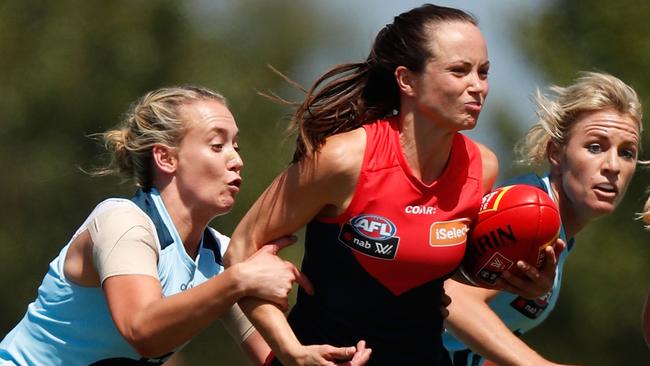 Daisy Pearce of the Demons is tackled by Lauren Arnell of the Blues. (Photo by Michael Willson/AFL Media/Getty Images)
