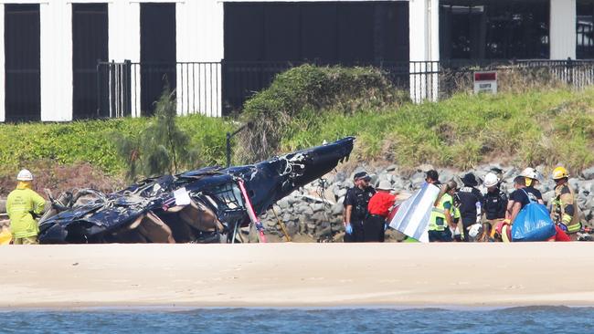 Emergency services at the scene of the Sea World Helicopters crash which claimed the lives of four people and seriously injured five others on January 2, 2023. Picture: Glenn Hampson