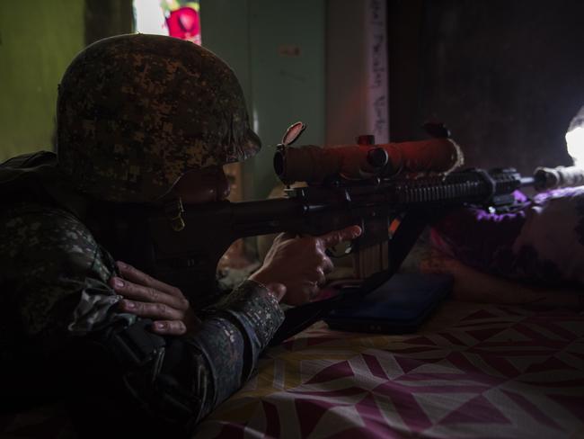 A government sniper training his sight on enemy positions in Marawi. Picture: Getty