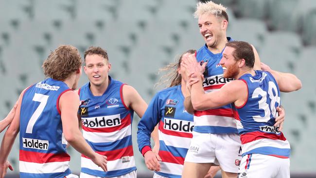 Central District’s Nick Lange is swamped by teammates after kicking a crucial goal in the draw with West Adelaide. Picture: Sarah Reed