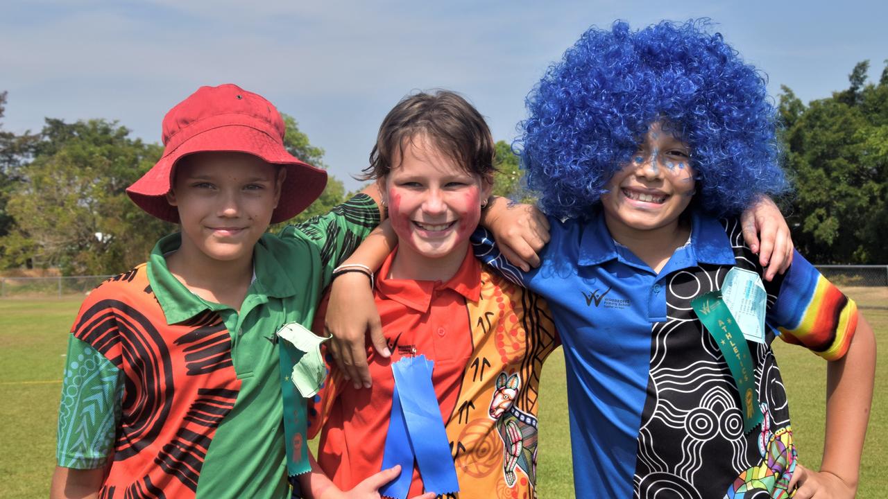 Woodroffe Primary School students Linton Noakes, Olivia Cole and Angel Dahoklory-Jones celebrate the last day of school at their athletics carnival on Friday. Picture: Sierra Haigh