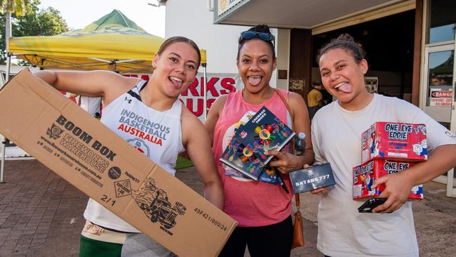 Lexxi Daly, Yazman Veavea and Daisha Daly at the Fireworks Warehouse at Darwin show grounds sale on Territory Day. Picture: Pema Tamang Pakhrin