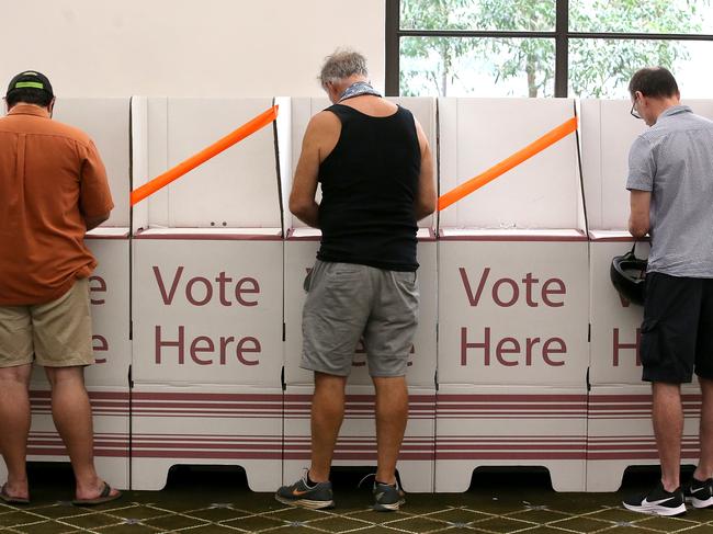 BRISBANE, AUSTRALIA - MARCH 28: Voters are seen keeping a distance at Brisbane City Hall on March 28, 2020 in Brisbane, Australia. Queensland local government elections and two state by-elections  are going ahead on Saturday, despite concerns about people gathering at polling stations amid the ongoing COVID-19 pandemic. Authorities will be imposing social distancing measures, and with a record number of pre-poll and postal votes, believe the risk of spreading the coronavirus is low compared to other day-to-day activities like visiting the supermarket. The Federal Government has introduced strict measures in response to the COVID-19 outbreak, requiring Australians to practise social distancing when outside their homes, banning large indoor and outdoor gatherings and limiting international and domestic travel to essential, work-related or compassionate only. All libraries, museums, galleries, beauty salons, tattoo parlours, shopping centre food courts, auctions, open houses, amusement parks, arcades, indoor and outdoor play centres, swimming pools are closed and indoor exercise activities are now banned along with bars, pubs, casinos and nightclubs. Restaurants and cafes are restricted to providing takeaway only. Weddings are now restricted to five people including the couple while funerals are limited to 10 mourners. All Australians are now expected to stay at home except for essential outings such as work, grocery shopping and medical appointments. Exercising outdoors alone is still permitted. Australia is approaching 3000 confirmed cases of COVID-19 while the death toll now stands at 13. (Photo by Jono Searle/Getty Images)