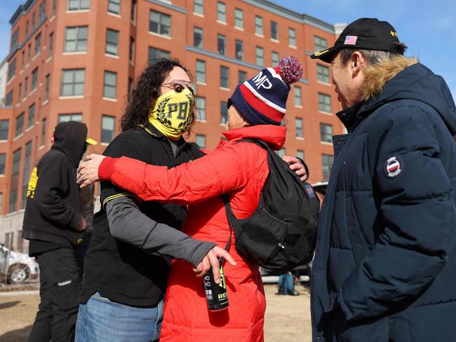 Proud Boys member Harry Fox is hugged by Stephanie Liu and Arthur Liu from New York outside the DC Central Detention Facility in Washington, DC. Picture: Getty Images