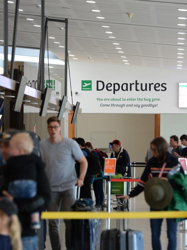 HOBART, AUSTRALIA - MARCH 19: Passengers line up at check in counter on March 19, 2020 at Hobart airport in Hobart, Australia. The Tasmanian premier Peter Gutwein has announced all interstate travellers will be required to quarantine for 14 days. The measures are the toughest to be imposed in Australia, and will come into effect from Friday 20 March. As of 1pm Thursday 19 March there are now 596 confirmed cases of COVID-19 In Australia, while there have been six confirmed deaths, five in NSW and one in Western Australia. (Photo by Steve Bell/Getty Images)