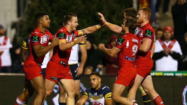 Euan Aitken of the Dragons celebrates his try.