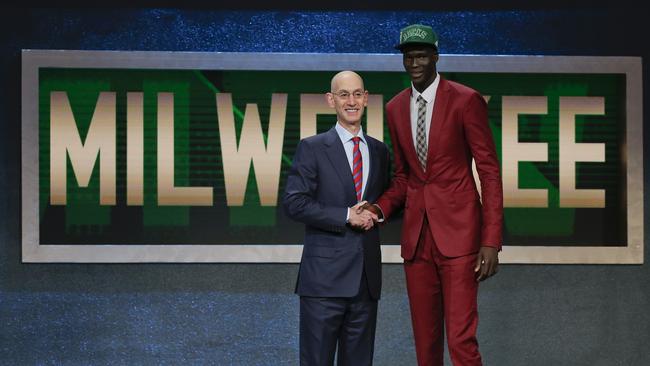 Thon Maker, right, poses for a photo with NBA Commissioner Adam Silver after being selected 10th overall by the Milwaukee Bucks.