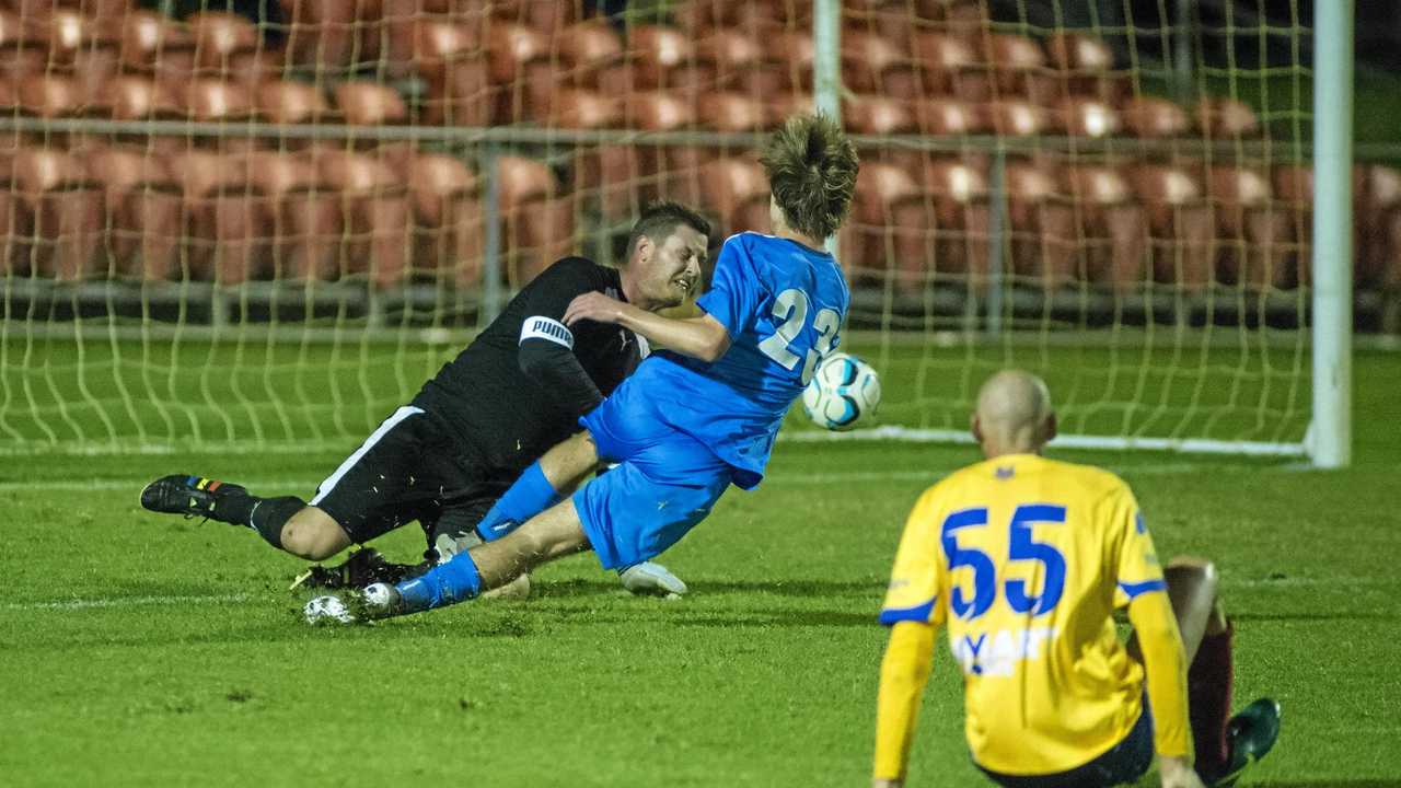 ON TARGET: USQ FC goalkeeper Matt Eilers saves a shot from South West Queensland Thunder Daniel Weber during their FFA Cup clash at Clive Berghofer Stadium. Picture: Kevin Farmer