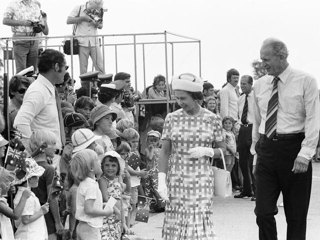 Families lines the streets to catch a glimpse of their Royal Majesty. The Queen is pictured with Former Administrator of the Northern Territory John England.