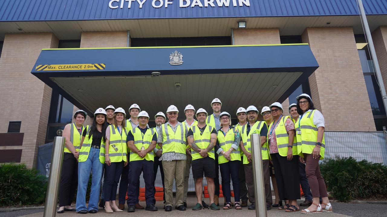 City of Darwin councillors and other stakeholders gather in front of the old council building.