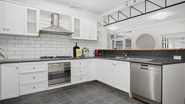 A kitchen with a SMEG oven, 900mm gas cooktop and rangehood, and a dishwasher.