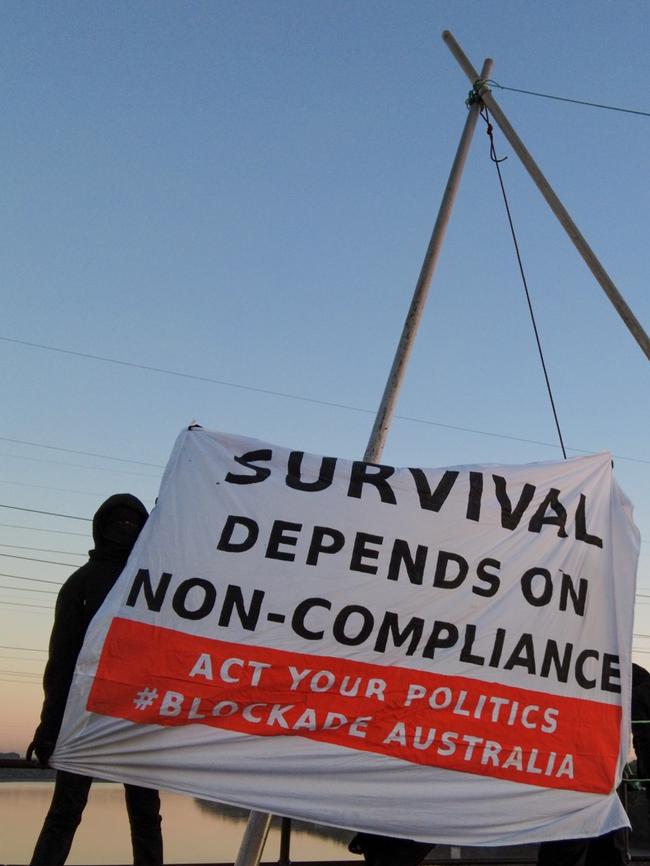 Ian Fox from Adelaide, age 67, climbed atop the Kooragang Rail Bridge and suspended himself over the Hunter River, blocking all rail in and out of the Port of Newcastle. Picture: Blockade Australia