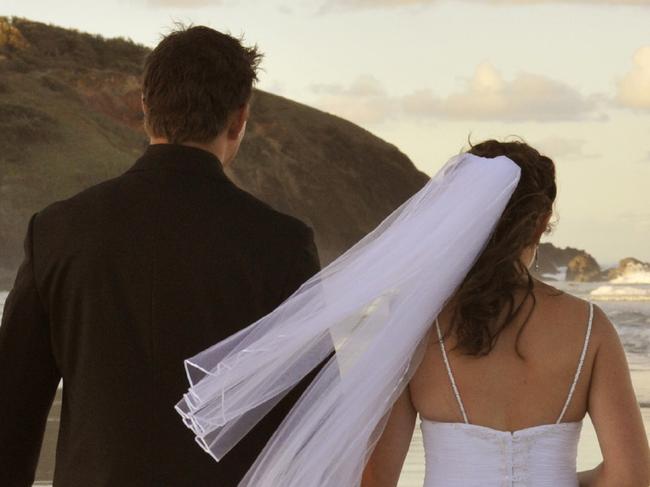 Generic image of bride and groom on a beach. From iStock.