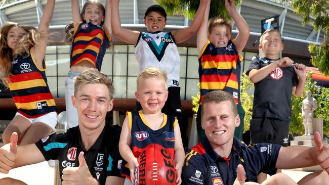 Port Adelaide’s Todd Marshall and Crow Reilly O’Brien, with footy fans Milana, Khloe, Jack, Max, Noah, Bodhi. Picture: Dean Martin