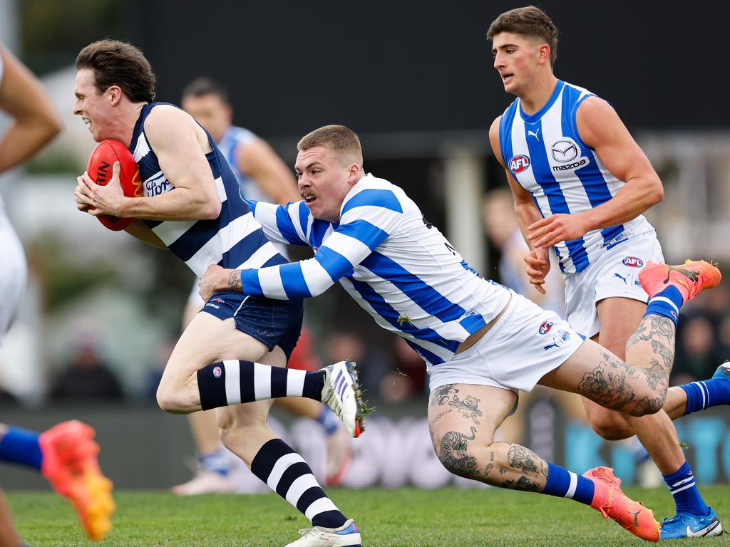 HOBART, AUSTRALIA - JULY 27: Max Holmes of the Cats is tackled by Cameron Zurhaar of the Kangaroos during the 2024 AFL Round 20 match between the North Melbourne Kangaroos and the Geelong Cats at Blundstone Arena on July 27, 2024 in Hobart, Australia. (Photo by Dylan Burns/AFL Photos via Getty Images)