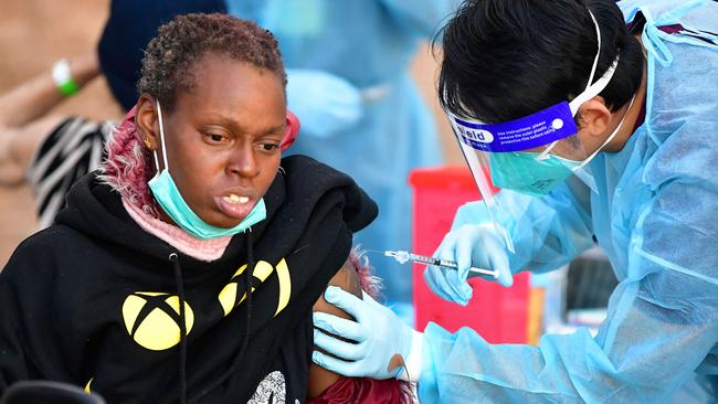 Registered Nurse Angelo Bautista administers the Moderna COVID-19 vaccine in LA. Picture; AFP.