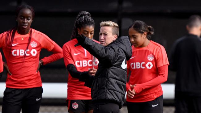 Canada's coach Bev Priestman (C) has stood down from the opening game. (Photo by William WEST / AFP)