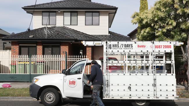 A glass repairman arrives to fix damage to the rental property. Picture: David Crosling