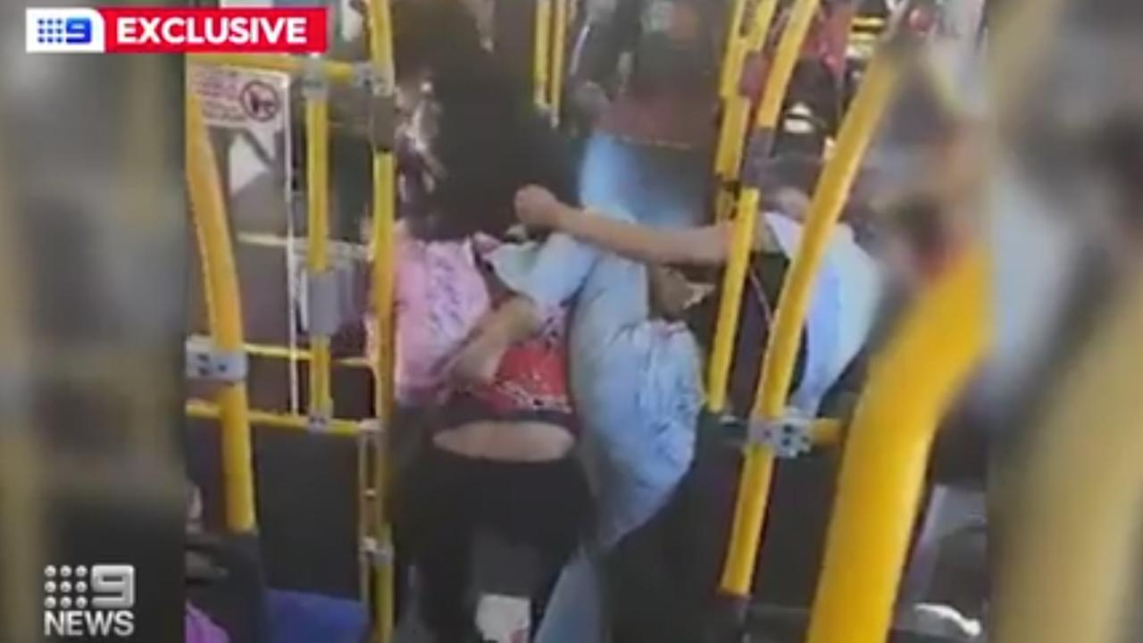 A woman, clutching her baby, was repeatedly hit during a brawl on a bus in Brisbane. Picture: Channel 9