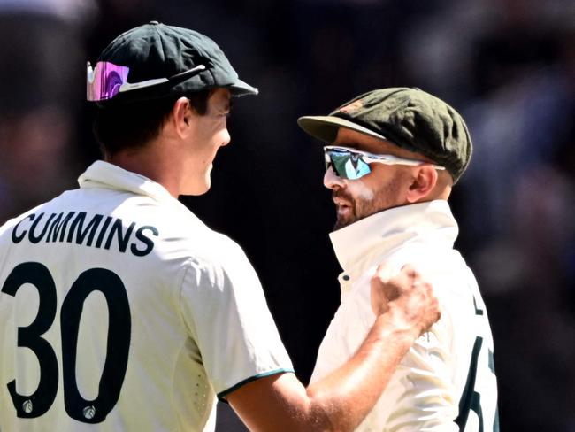 Australia's captain Pat Cummins congratulates Nathan Lyon after Lyon dismissed Indian batsman Nitish Kumar Reddy on the fourth day of the fourth cricket Test match between Australia and India at the Melbourne Cricket Ground (MCG) in Melbourne on December 29, 2024. (Photo by William WEST / AFP) / --IMAGE RESTRICTED TO EDITORIAL USE - STRICTLY NO COMMERCIAL USE--