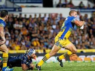 Eels Danny Wicks makes a break from the tackle of Cowboys co-captain Johnathan Thurston during the round 8 NRL match between the North Queensland Cowboys and the Parramatta Eels at 1300 Smiles Stadium in Townsville, Saturday, April 23, 2016. Picture: MICHAEL CHAMBERS