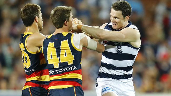 Matt Crouch and Richard Douglas get stuck into Patrick Dangerfield. Picture: Michael Klein