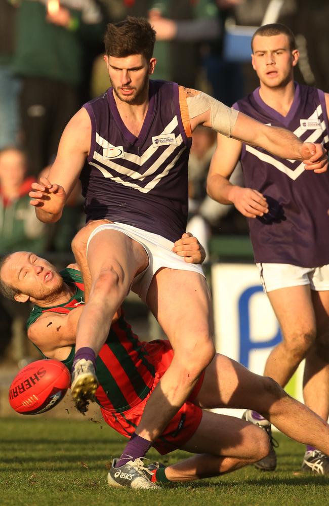 Templestowe’s Adrian Fancellu gets boots to ball in the nick of time. Picture: Stuart Milligan.