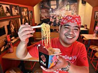 SMILES FOR NOODLES: P'Nut Street Noodles head chef Nut Kunlert with tasty noodles at his restaurant in Kawana Shoppingworld. Picture: Warren Lynam