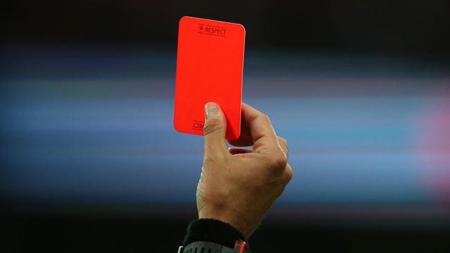 A referee shows a red card.