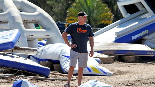 Jason Stone inspects what is left of his inflatable fun park. Picture: Nathan Edwards