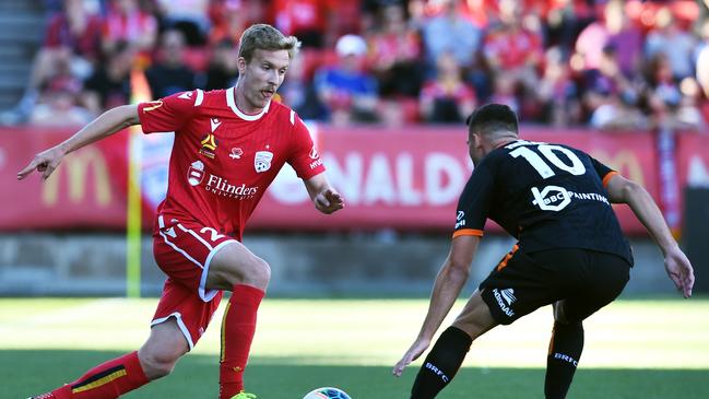 Adelaide United’s Ben Halloran looks to be the hardet to keep for next season. Halloran in action against SA’s Bradden Inman of Brisbane Roar at Coopers Stadium on November 10. (Photo by Mark Brake/Getty Images)