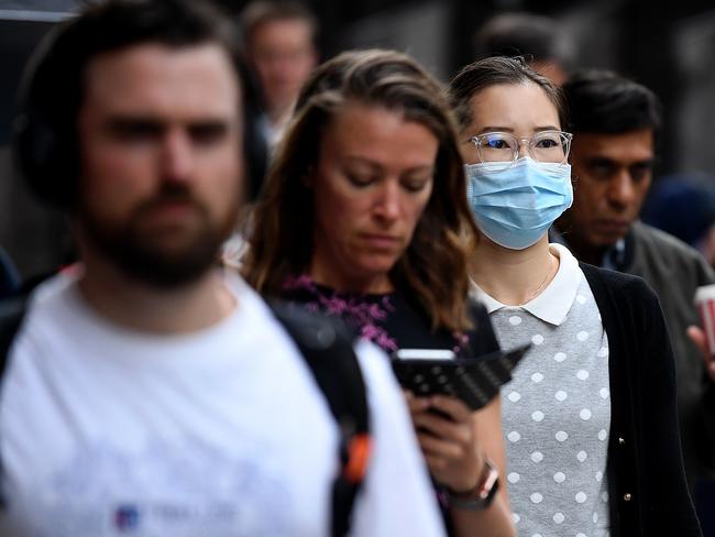 A woman wearing a face mask as a preventative measure against coronavirus COVID-19 in Sydney, Monday, March 16, 2020. (AAP Image/Joel Carrett) NO ARCHIVING