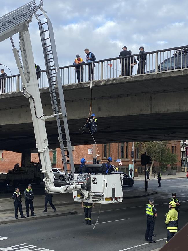 Extinction Rebellion protester Ms Throrne being removed from Morphett St Bridge. Picture: Agnes Gichuhi