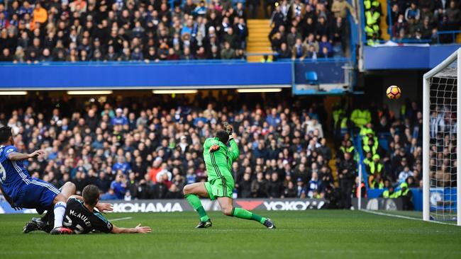 Costa (L) shoots past West Bromwich Albion's English goalkeeper Ben Foster (R) to score.