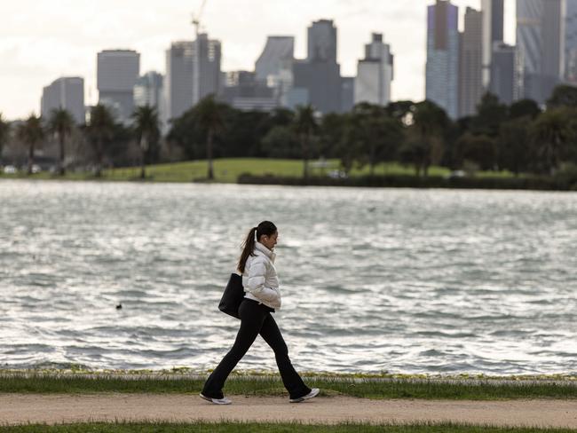 MELBOURNE, AUSTRALIA - NewsWire Photos - 24 JULY 2024: Clouds are seen above the Melbourne skyline as people walk through Albert Park. Picture: NewsWire / Diego Fedele