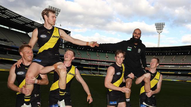 Retiring Tigers David Astbury and Bachar Houli are chaired off the MCG. Picture: Michael Klein