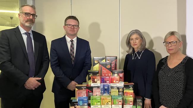 SA Health protection and licensing services executive director Chris Lease, health minister Chris Picton, chief public health officer Professor Nicola Spurrier and Sara Driver whose two teenage daughters became addicted to vapes, in front of seized vapes containing nicotine. Picture: Brad Crouch