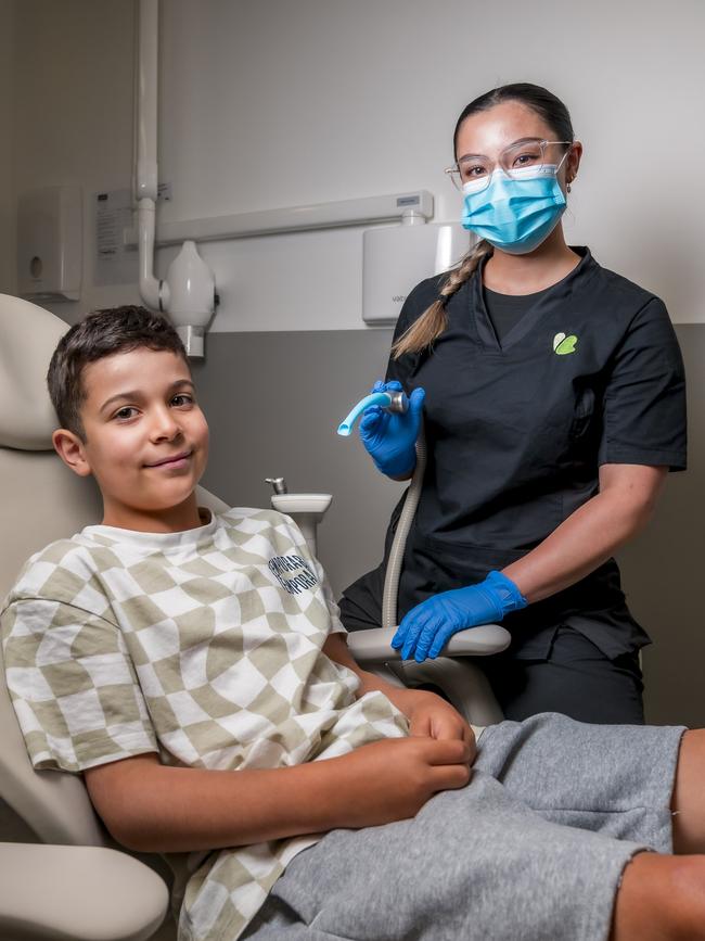 Ryan Shukri-Gilmore, 7, and dental assistant April Mansbridge. Picture: Caroline Tan