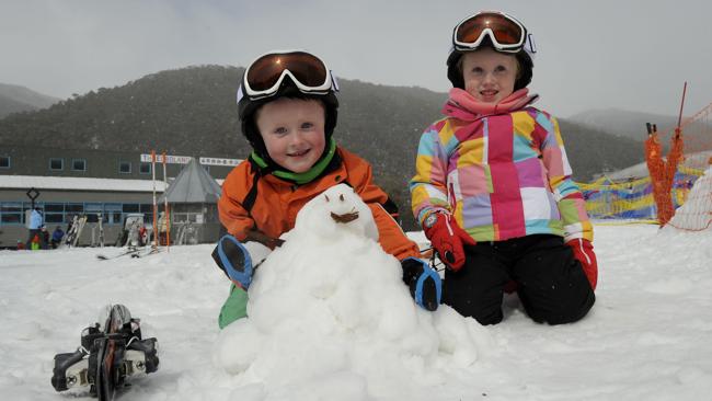 Toby and Caitlyn Harisson playing in the snow at Thredbo on Thursday. Picture: Steve Cuff