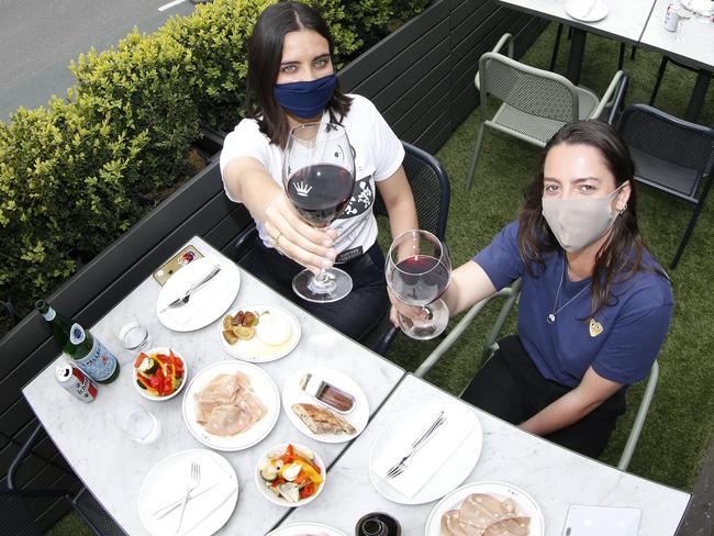 Cafe King and Godfree in Carlton on the corner of Lygon and Faraday streets, will transform on-street car parking spaces transformed into an outdoor dining scene. Diners Clementine Donohoe and Milly Middleton testing out the new concept for Melbourne cafes and restaurants.    Picture: David Caird