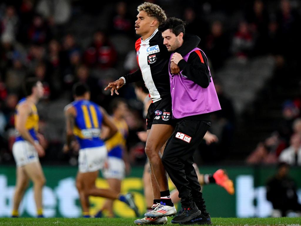 Liam Henry is helped from the field after being hurt. Picture: Josh Chadwick/AFL Photos/via Getty Images