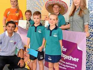 WELCOME VISIT: Woolworths' JaimeMauro, former pupils Chloe Crocker and Chelsea Newing with the bounty for Noosaville State School kids. Picture: Peter Gardiner