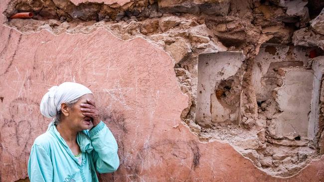 A woman reacts standing in front of her earthquake-damaged house in the old city in Marrakesh. Picture: AFP